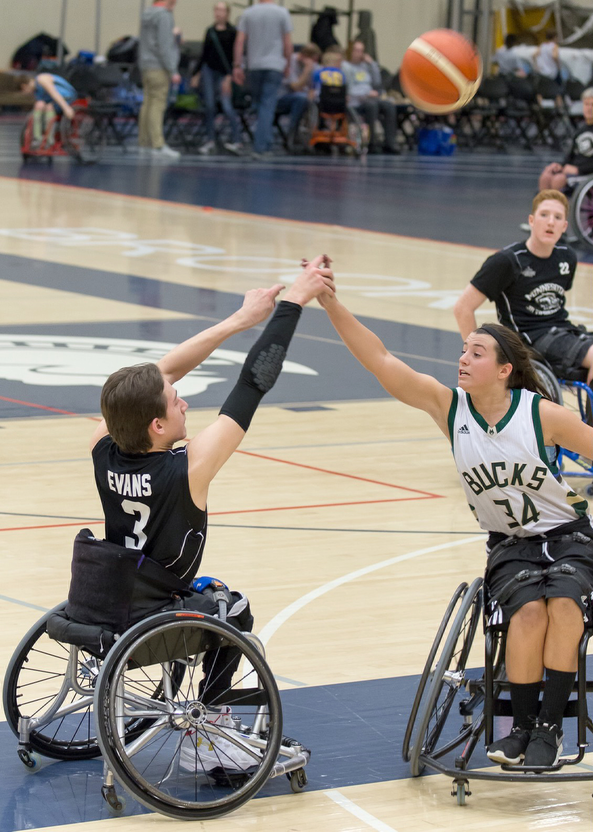 Evans playing wheelchair basketball against the Bucks